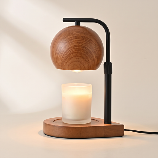 Walnut candle warmer lamp with a black arm warming a jar candle from above, switched on