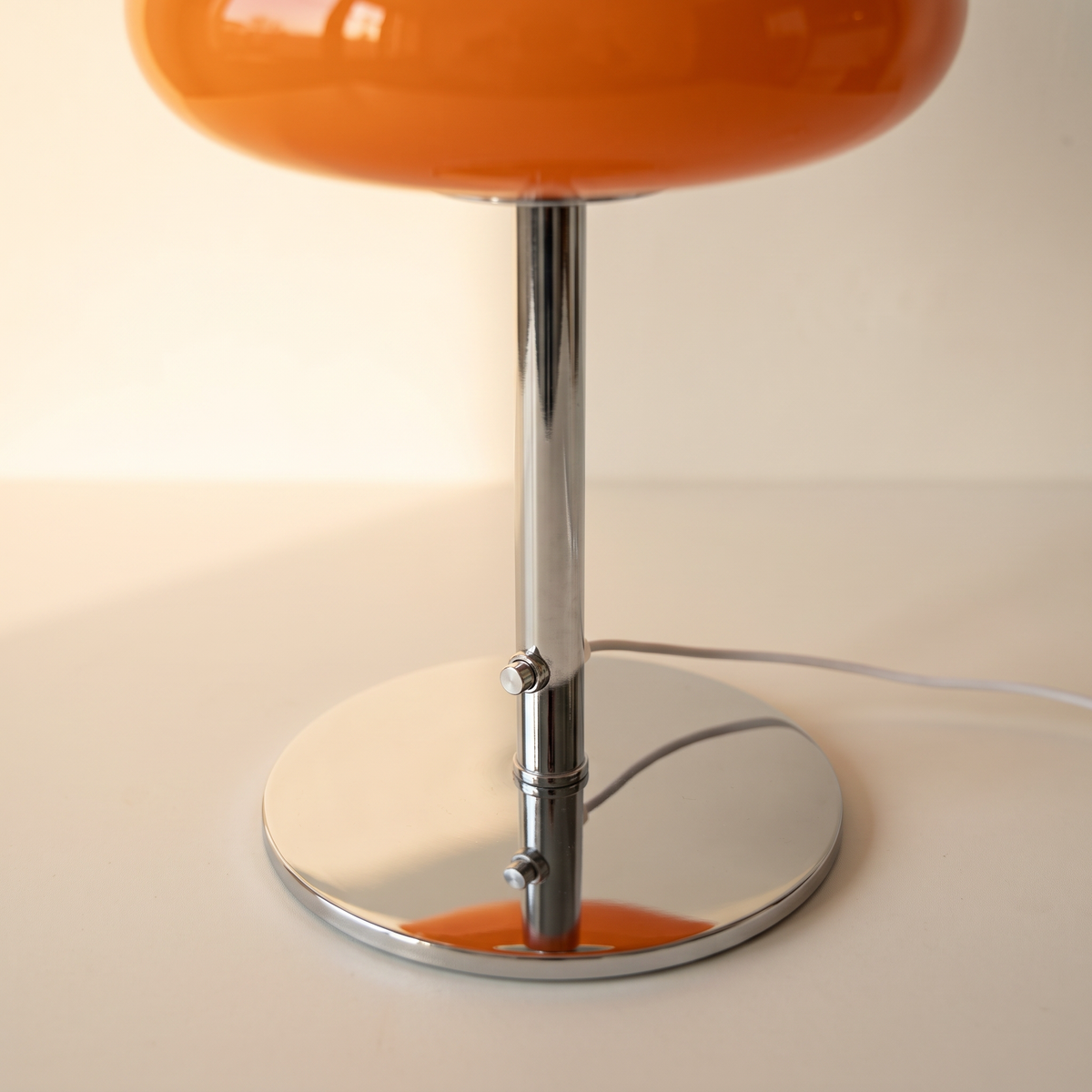 Close up of the chrome stem, the push button switch and the round chrome base