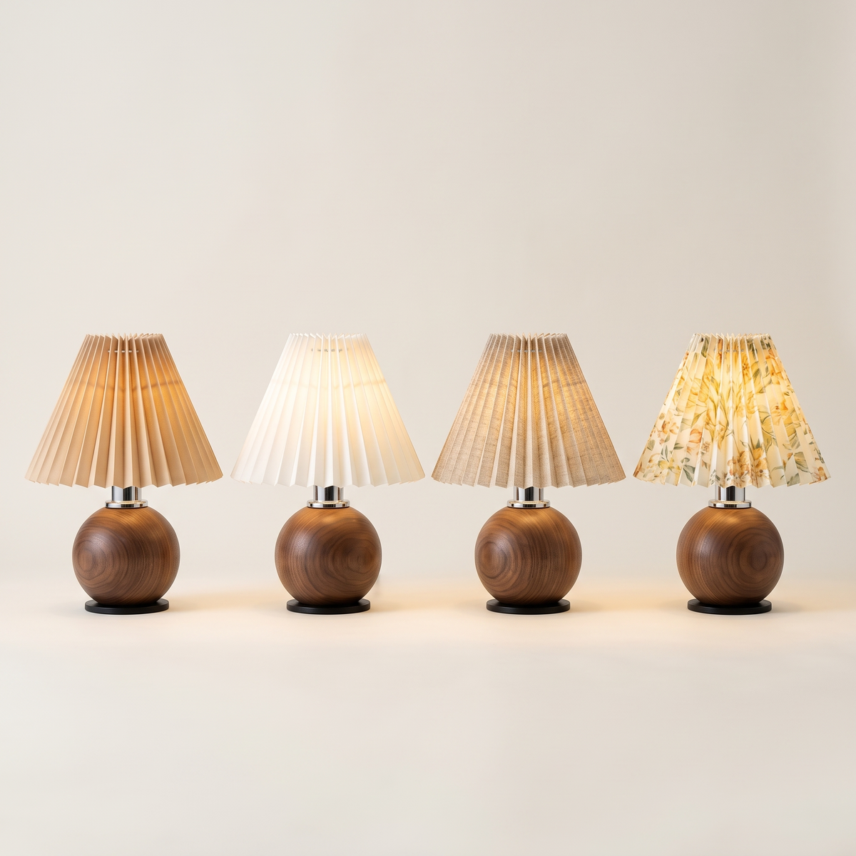Four wooden ball table lamps in a row with beige, off-white, linen and floral pleated shades