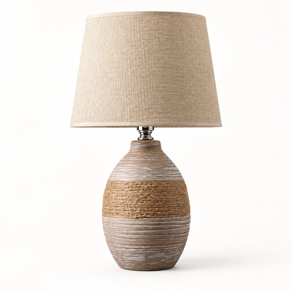 Taupe ceramic table lamp with a natural rope band and an oatmeal linen drum shade on a white background